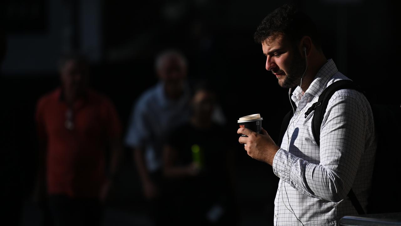 A person with a coffee on their morning commute