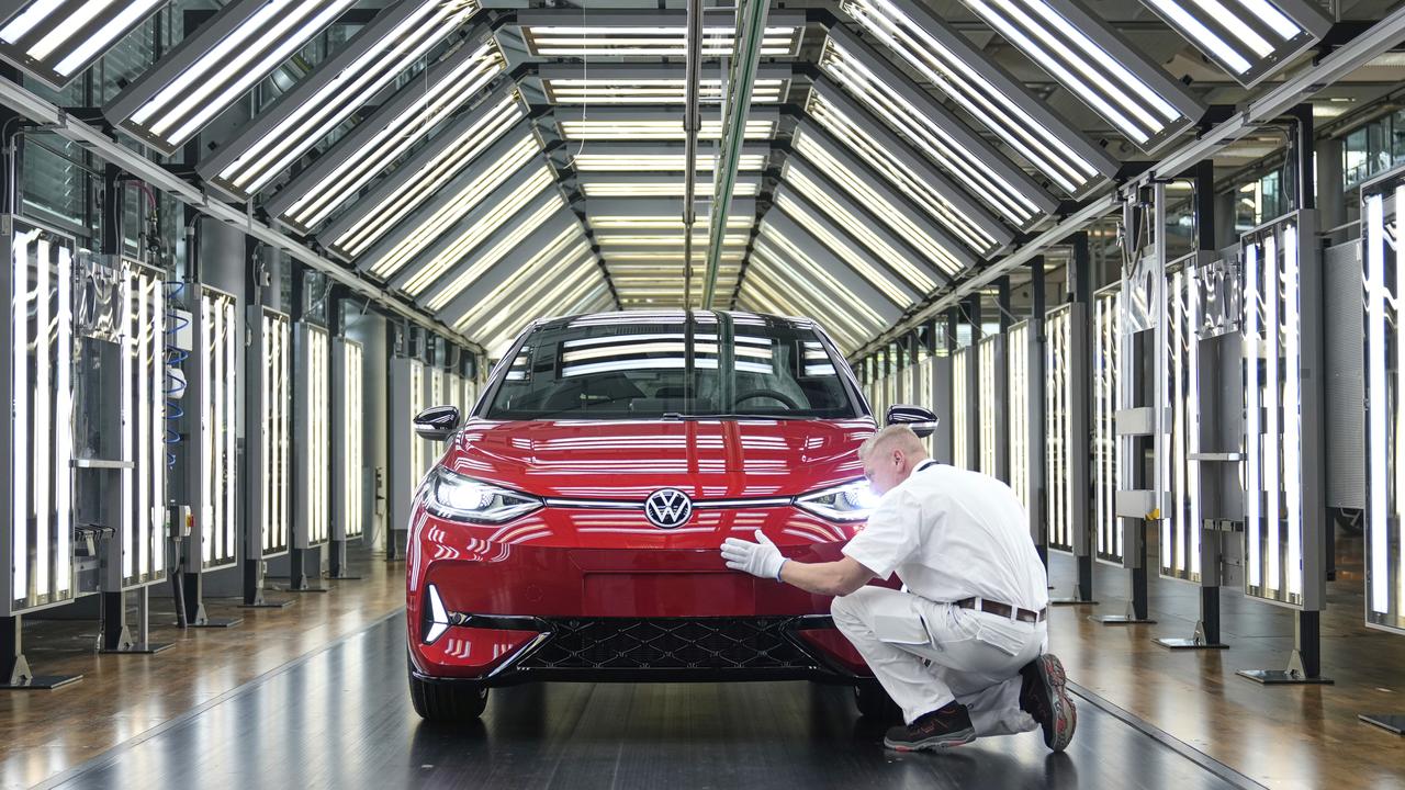 Employee of the German car manufacturer Volkswagen checks thae car