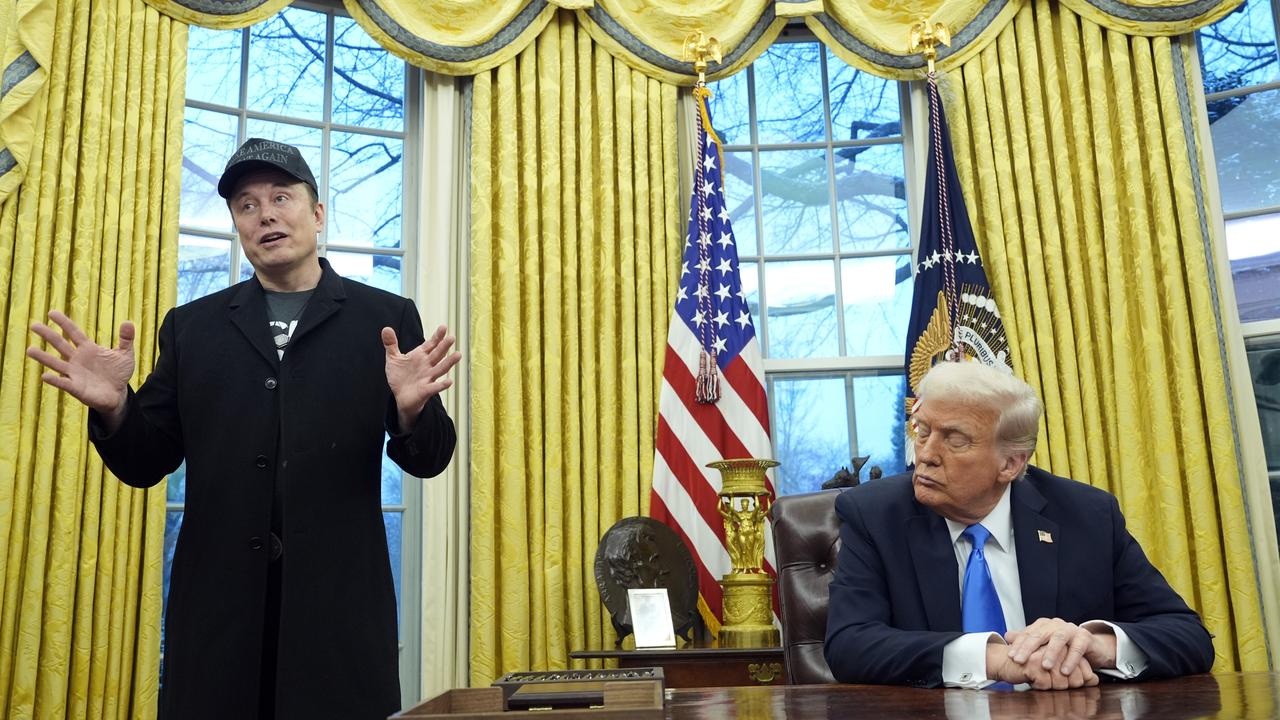 President Donald Trump listens as Elon Musk speaks in the Oval Office