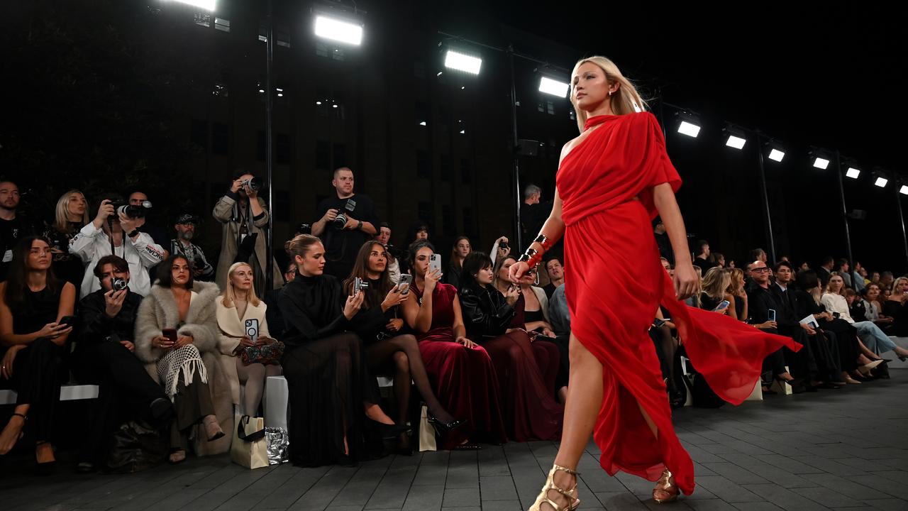Model in red dress on runway