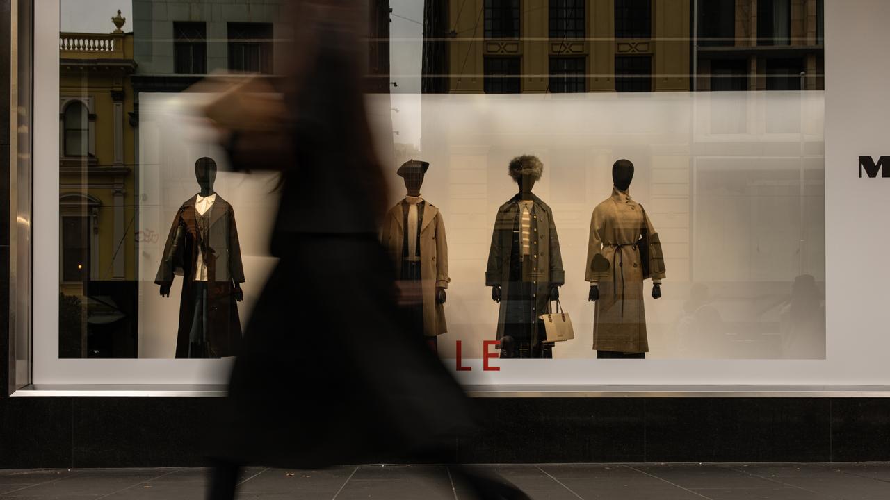 Woman walks past retail fashion display