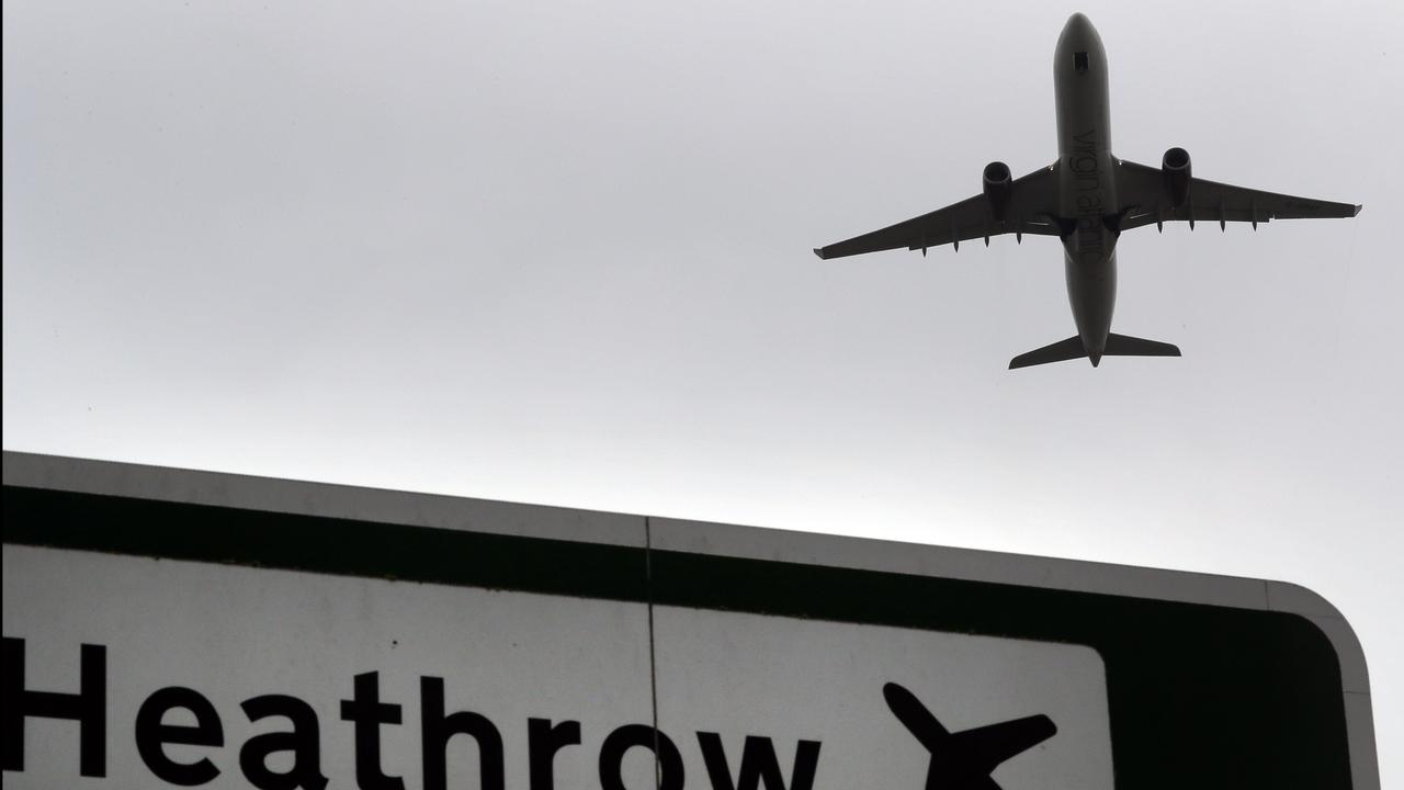 Plane takes off over a road sign near Heathrow Airport in London
