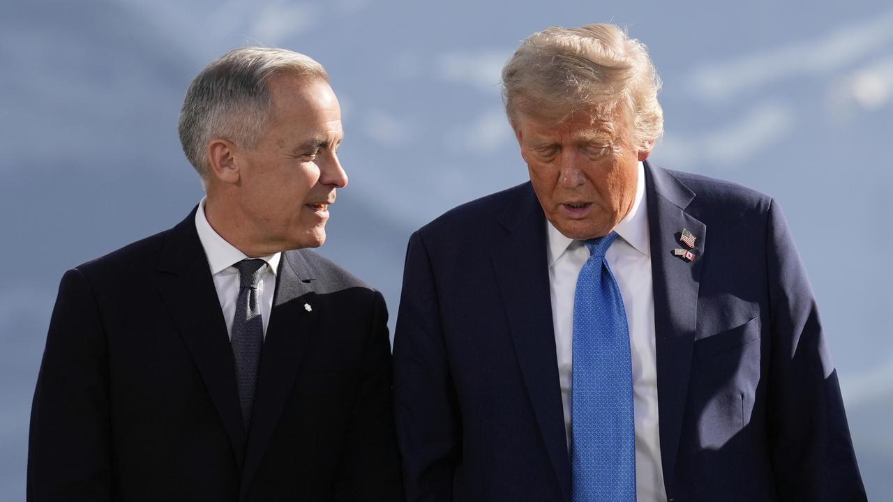 Canada's Prime Minister Mark Carney talks with President Donald Trump