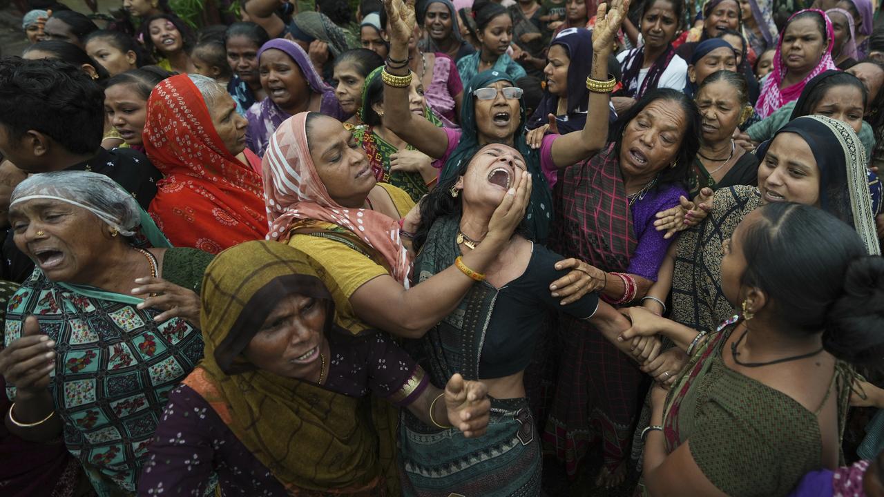 Relatives mourn at the funeral of an Air India crash victim