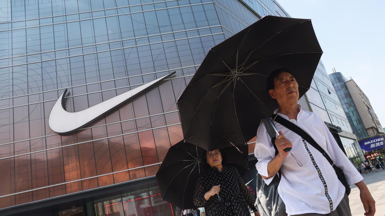 People walk near the Nike store in Beijing