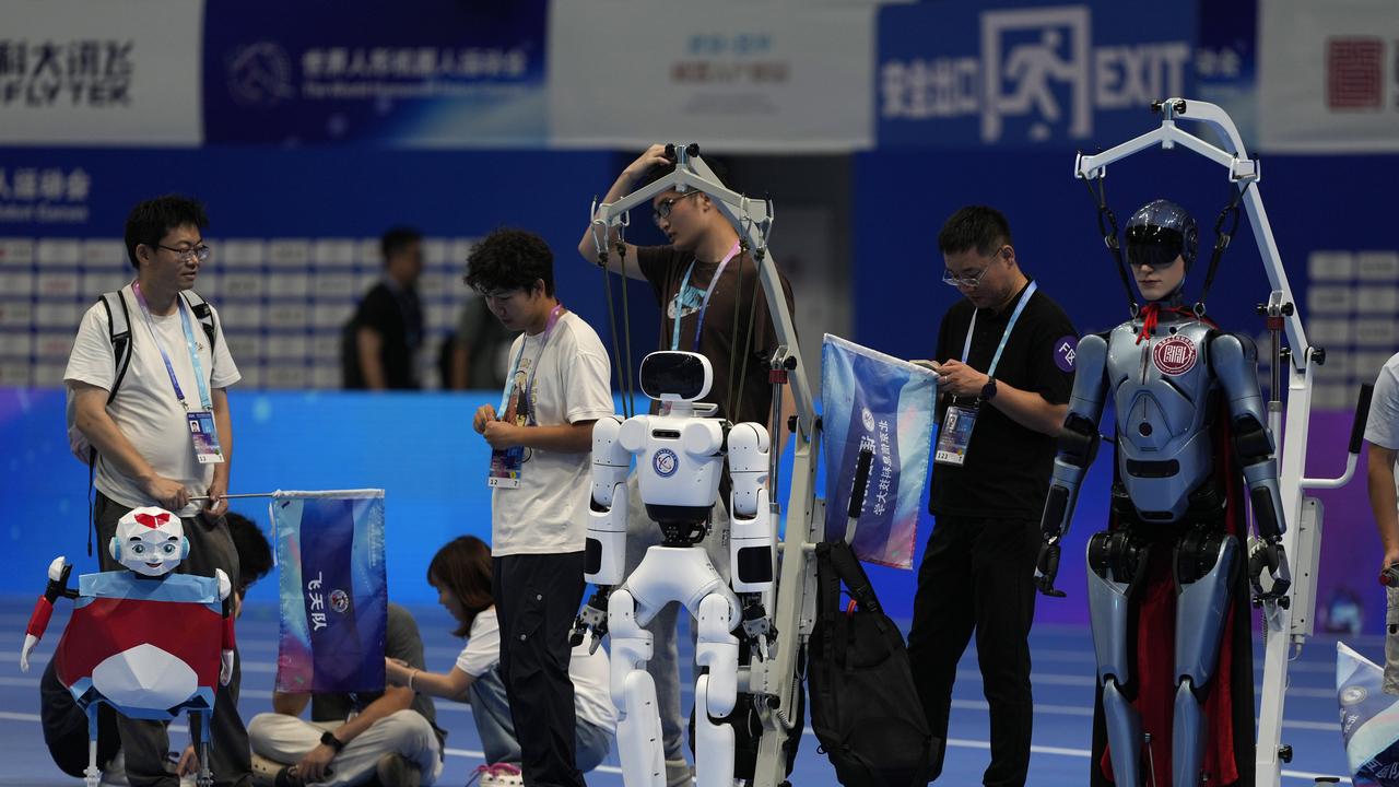 Robots are prepared ahead of an opening ceremony