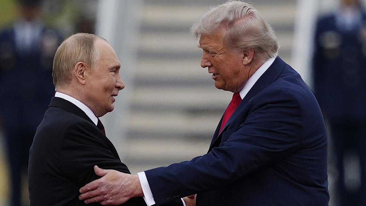 Donald Trump greets Russia's President Vladimir Putin