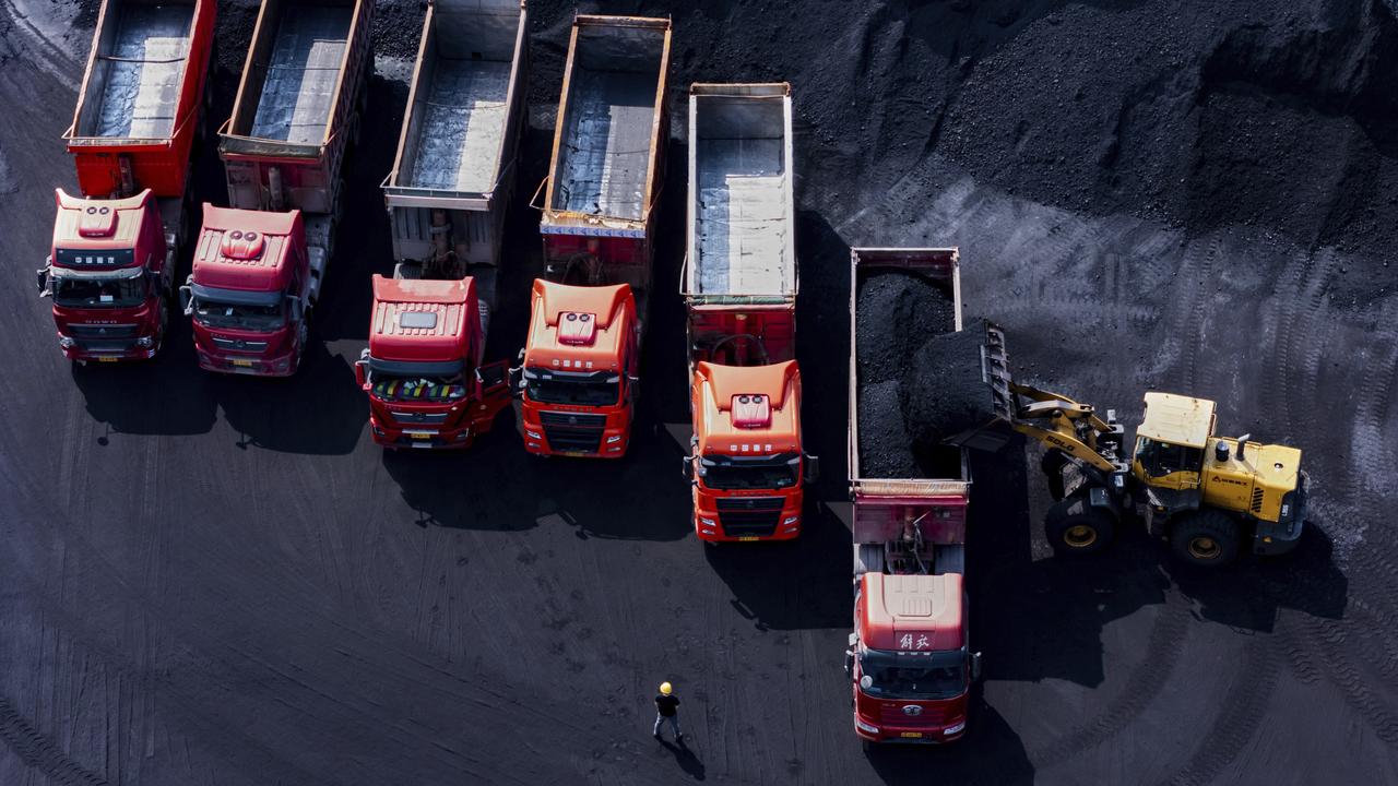Workers load coal on trucks in China (file image)