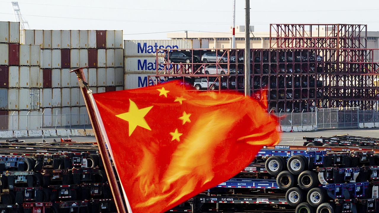 A Chinese flag flies from a ship at the port of Oakland, California