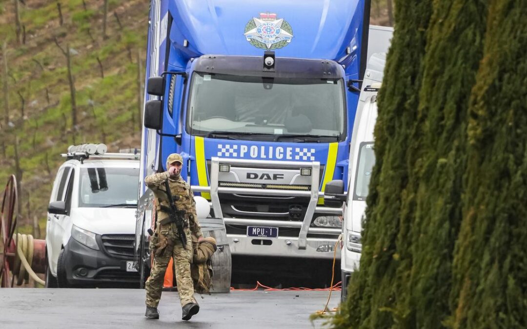 Public warned over fugitive as police search properties