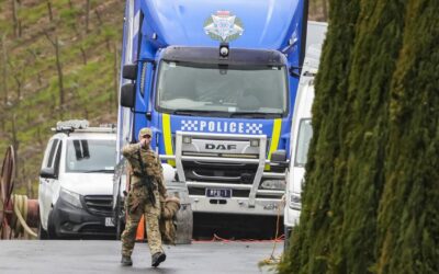 Public warned over fugitive as police search properties