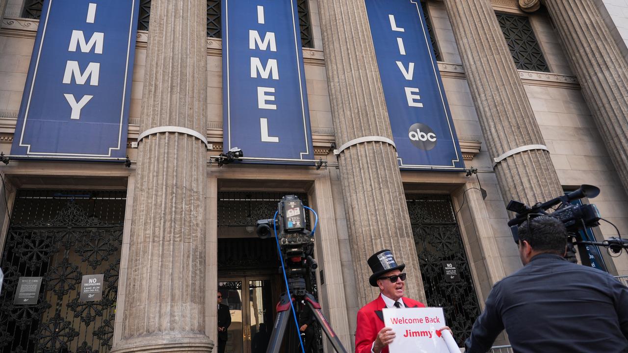 Gregg Donovan holds a sign that says "Welcome Back Jimmy"