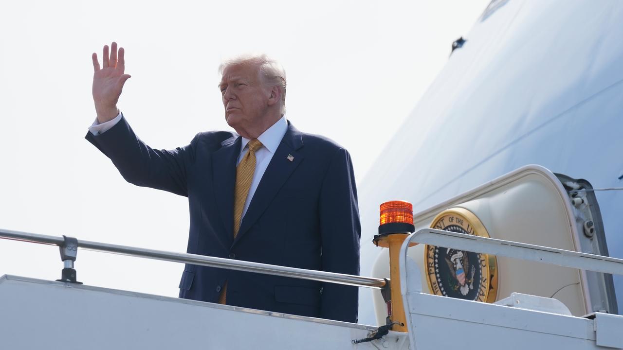 President Donald Trump waves as he boards Air Force One
