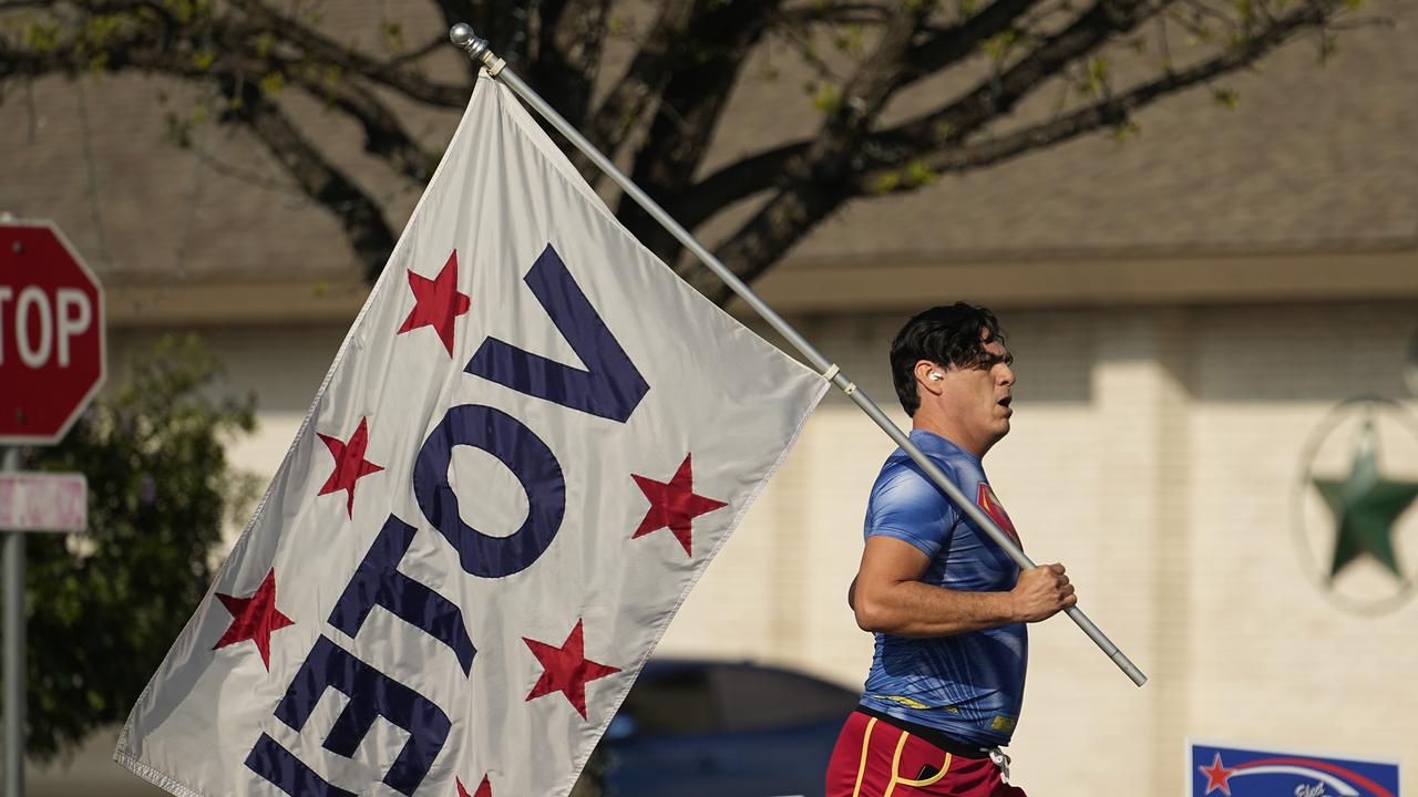 Artist David Alcantar jogs past a polling site,