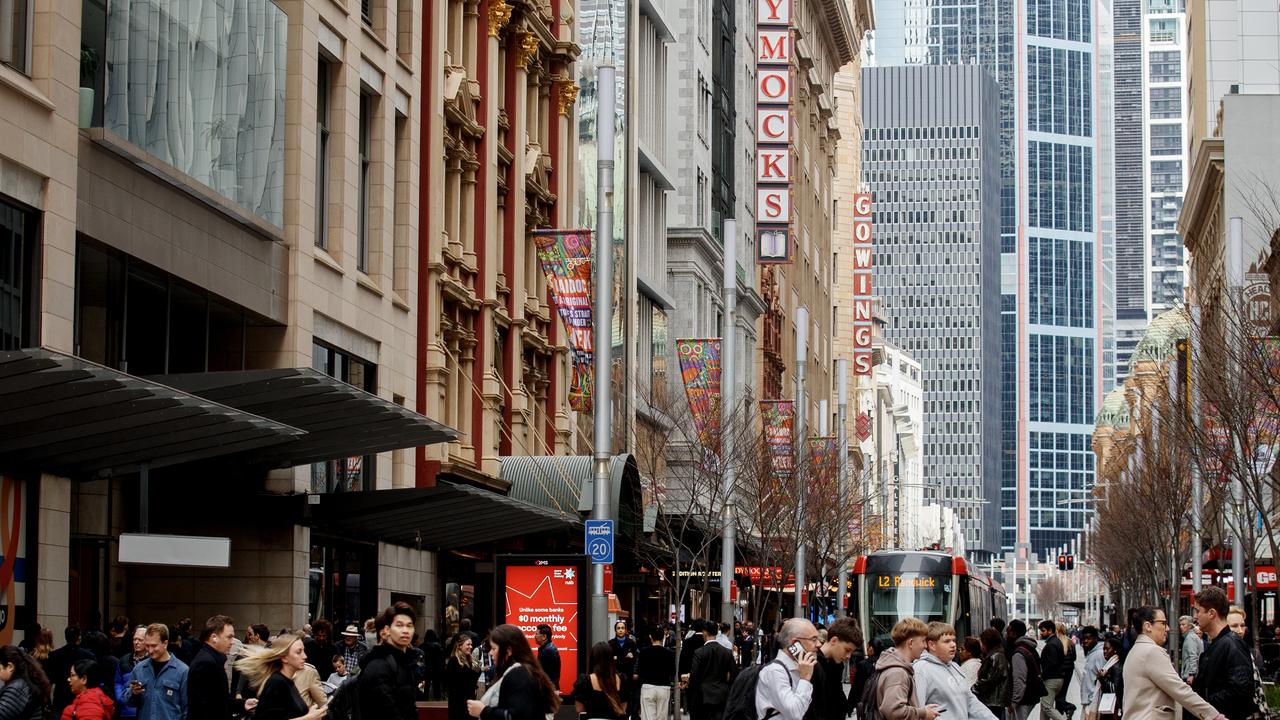 People move through George Street in the CBD of Sydney