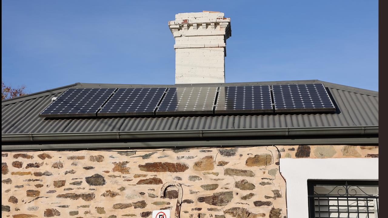 Solar panels are seen on the roof of a property