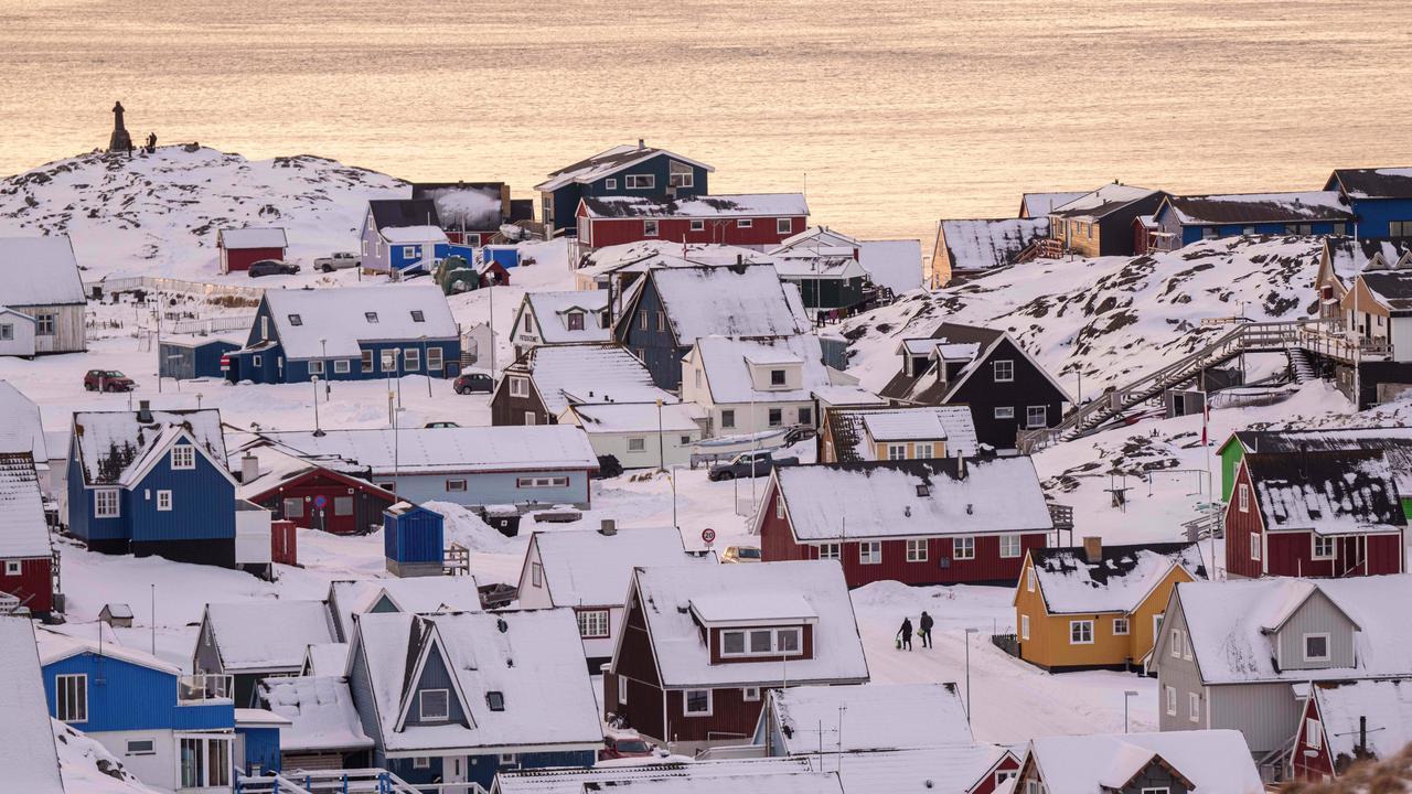 People walk on a street in Nuuk, Greenland