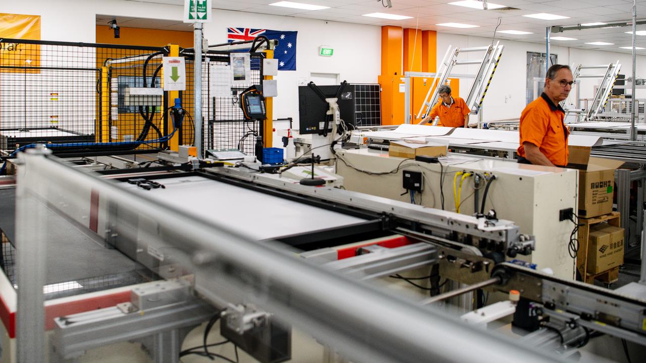 Workers make solar panels (file image)