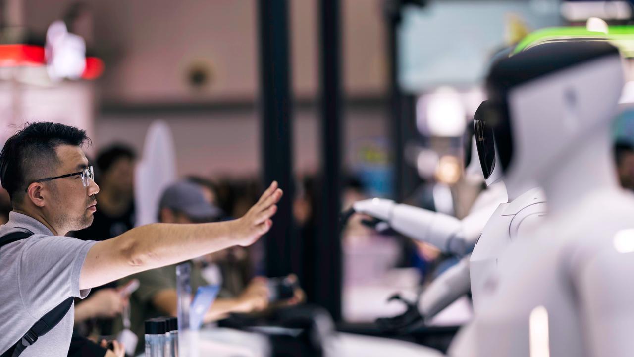 A visitor interacts with robots on display