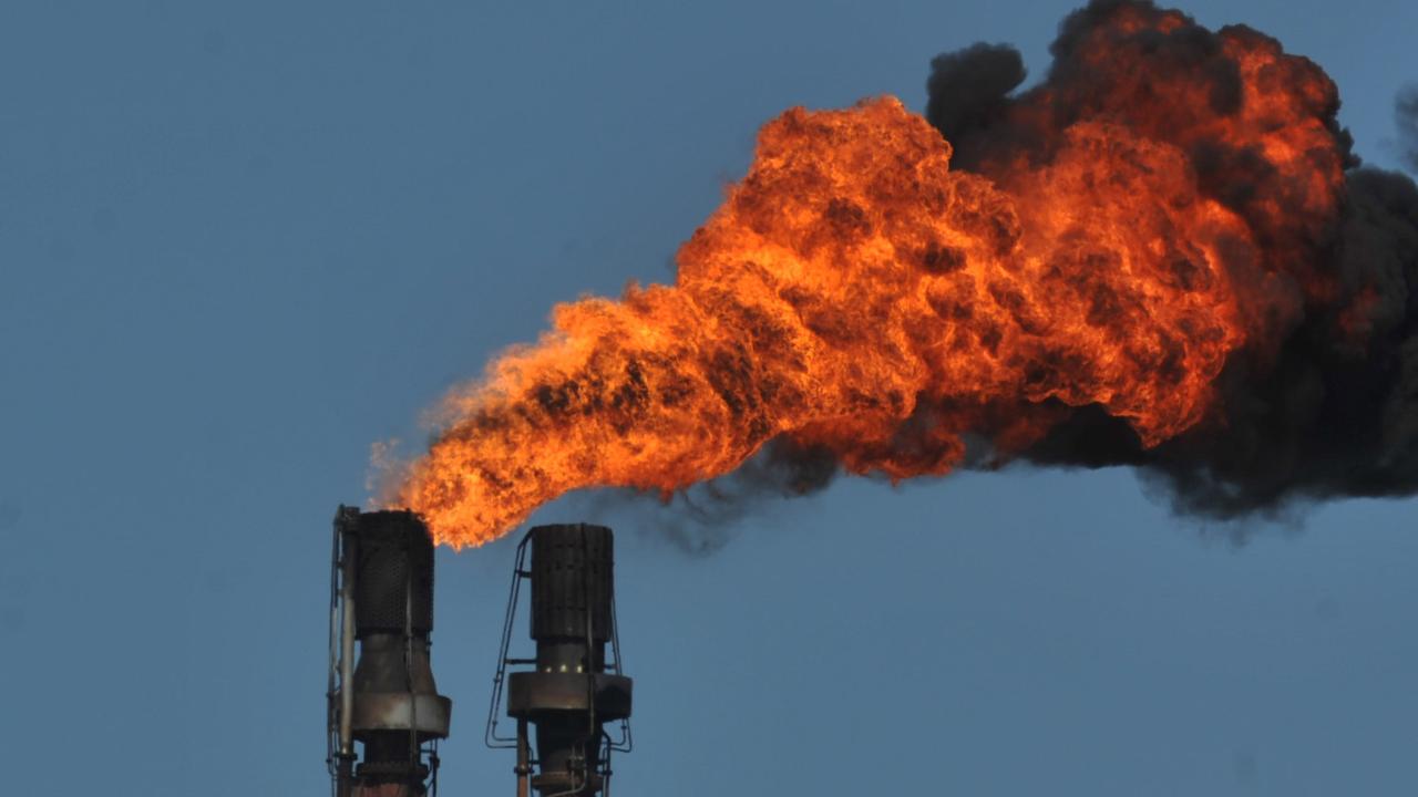 Smoke spews from an industrial chimney