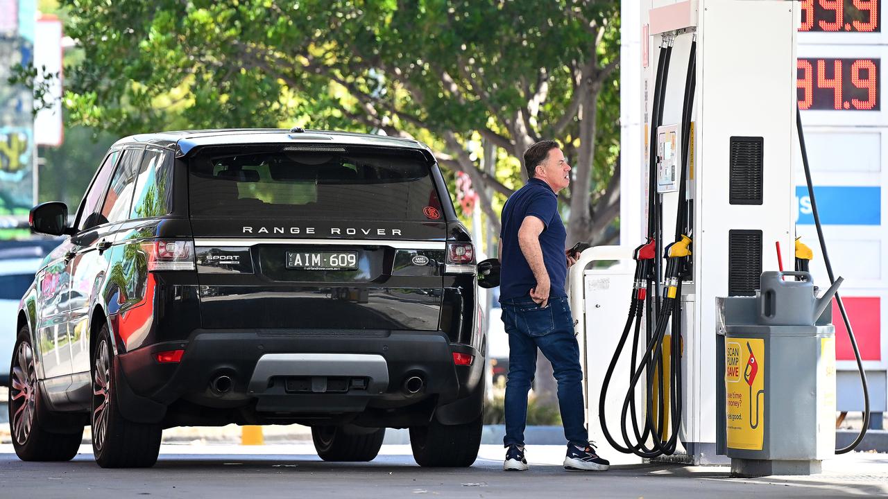 People fill up at a petrol station (file image)