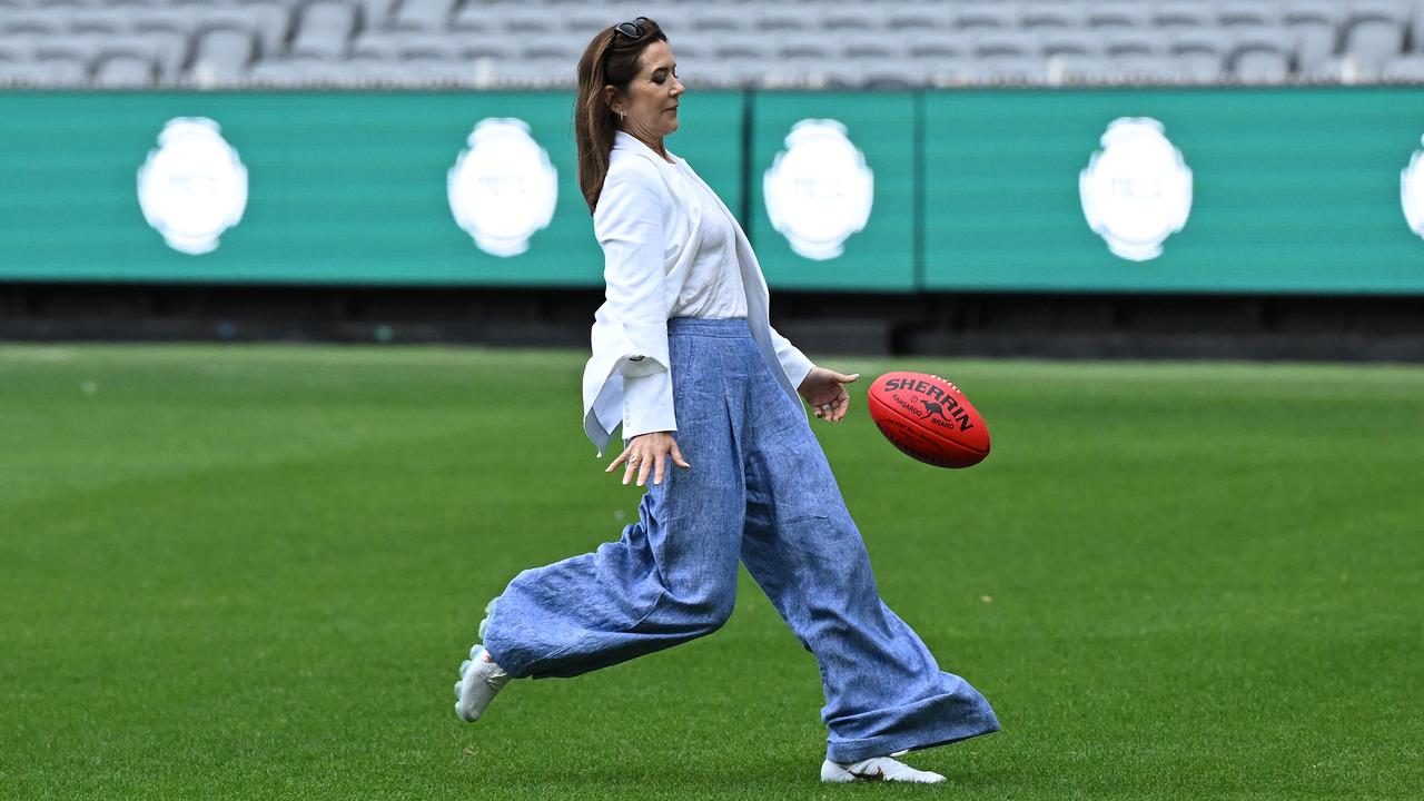 Denmark's Queen Mary kicks a football at the MCG