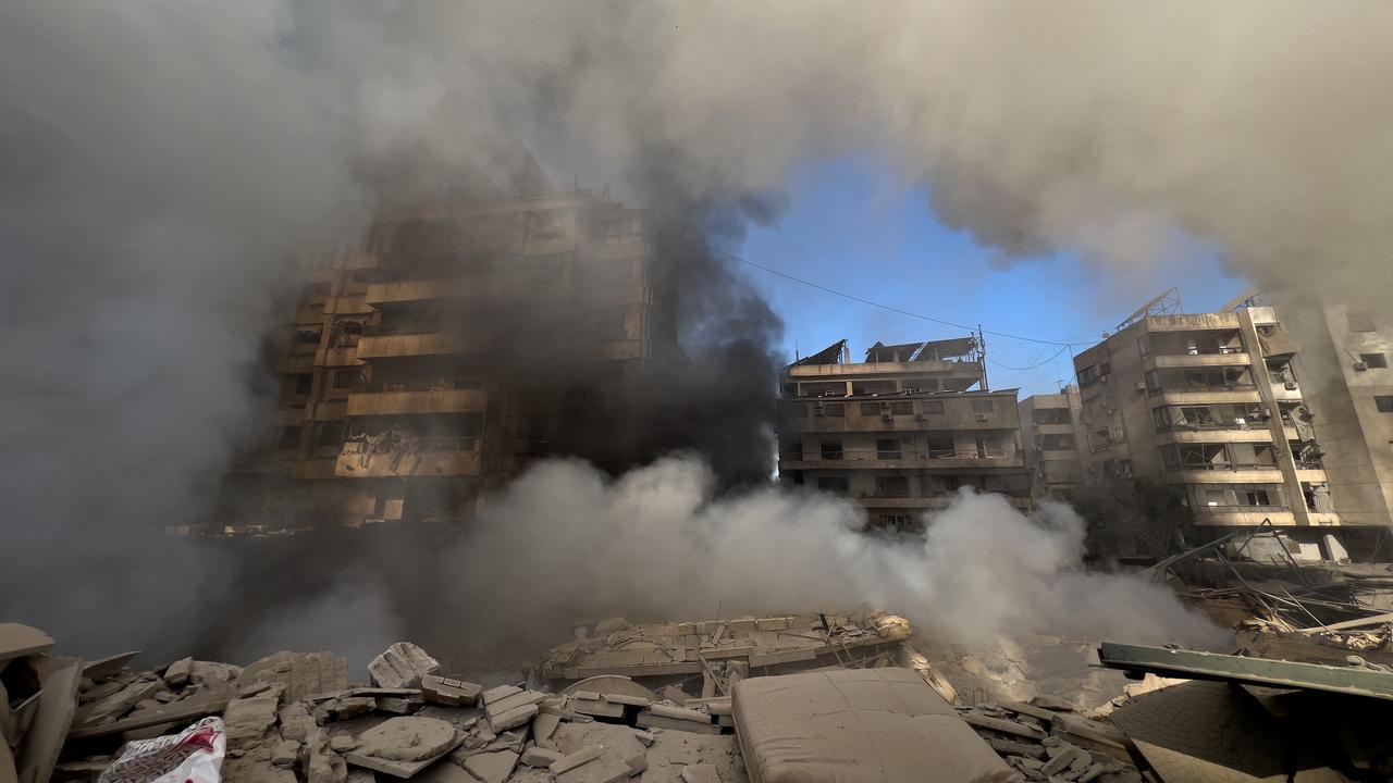 Smoke rises from destroyed buildings