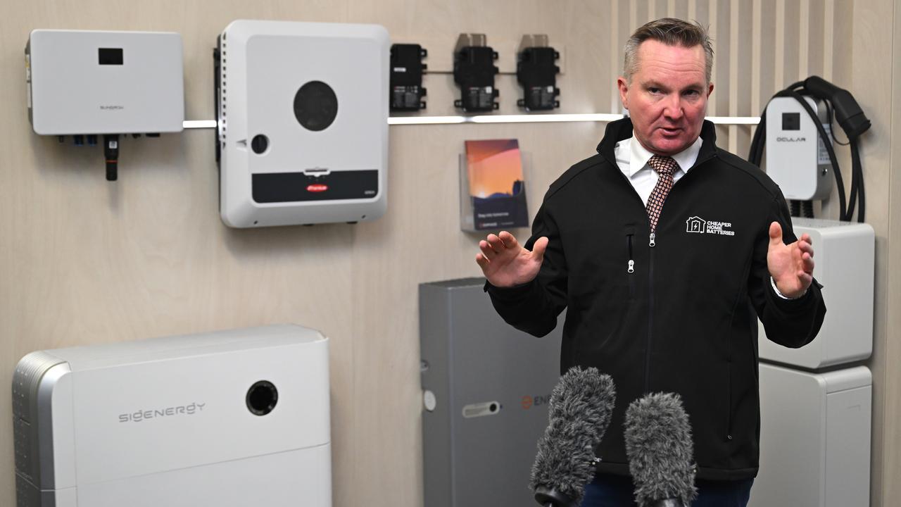 Energy Minister Chris Bowen in front of home battery systems