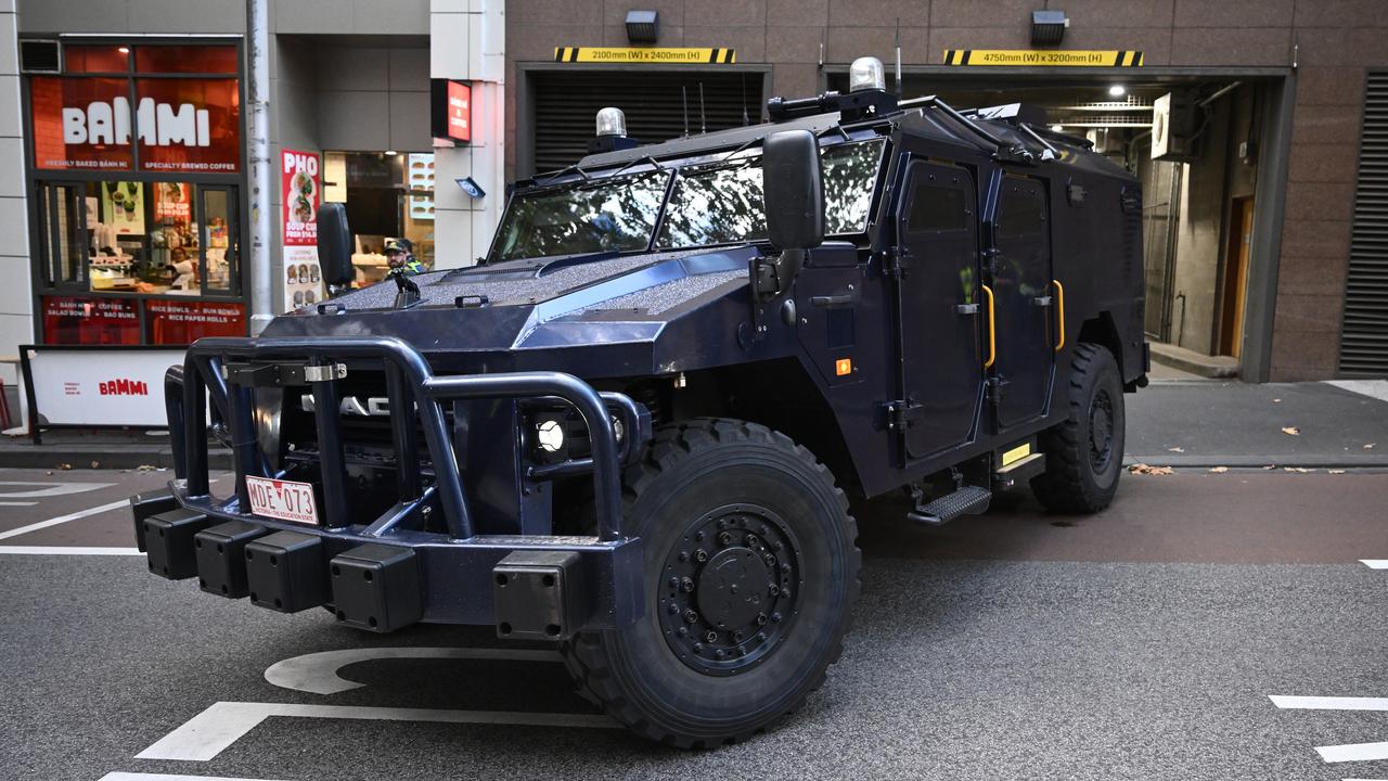 An armoured prisoner transport vehicle leaves court