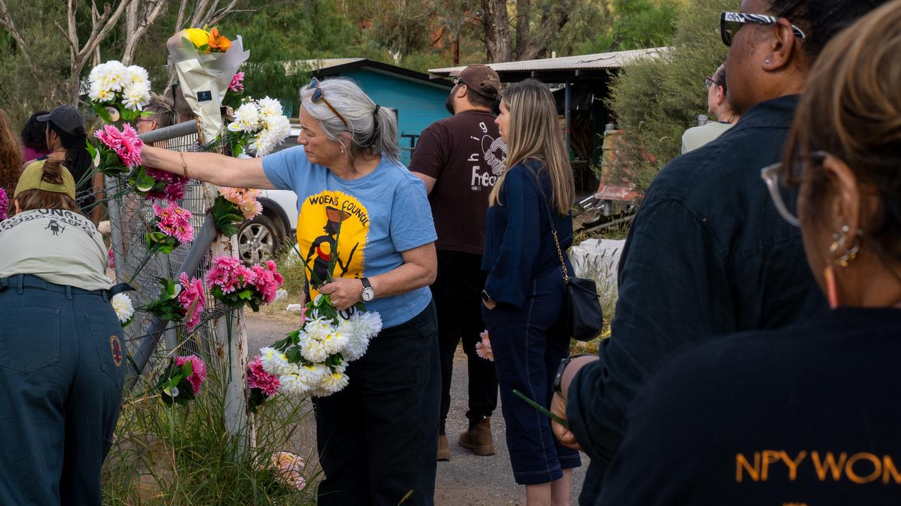 Alice Springs residents leave flowers on gates and fences