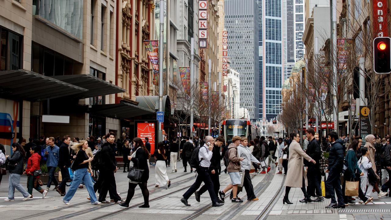 People move through George Street in the CBD of Sydney