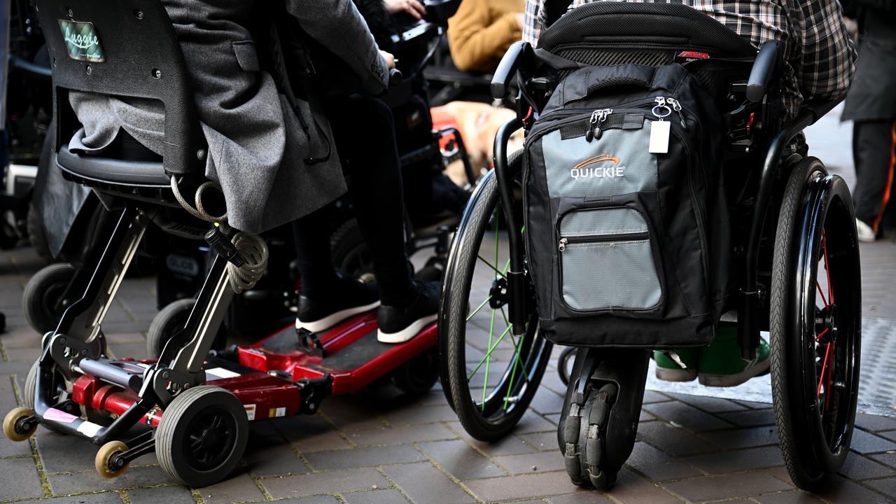 People using a mobility scooter and wheelchair (file image)