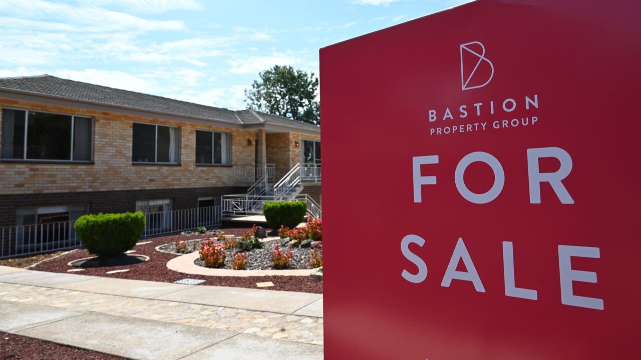 A 'For Sale' sign is seen near a house
