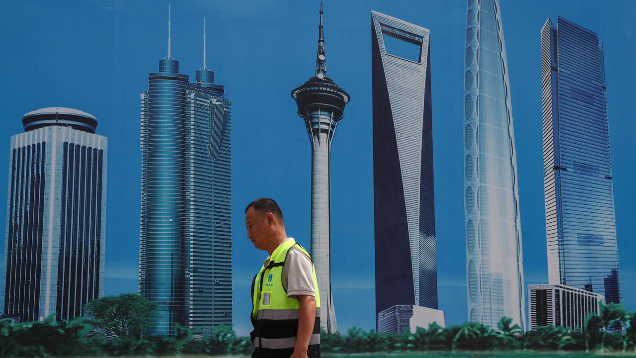 A construction worker walks on a street in Beijing, China