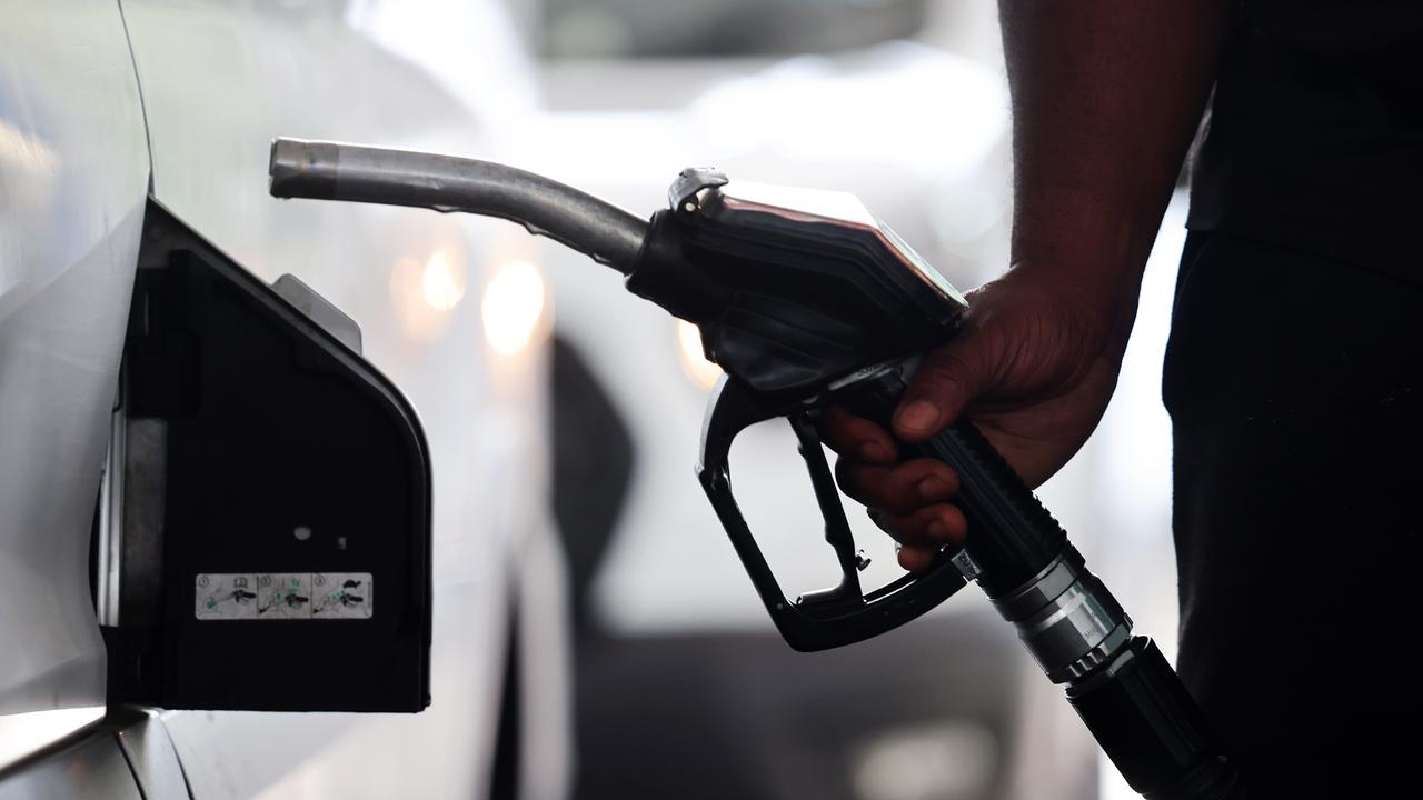 A customer fills his tank at a petrol station in London