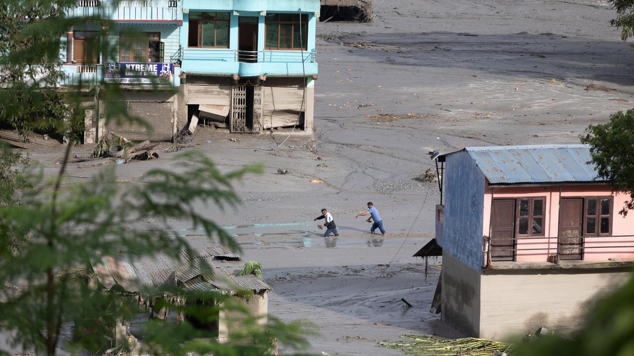 Two residents walked through the flood in Bidur Municipality