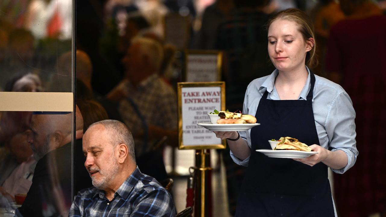 A cafe worker serves coffee