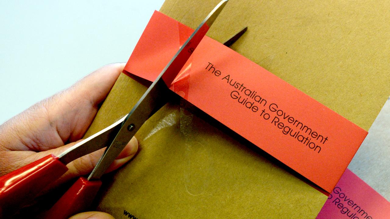 Scissors cutting red tape (file image)