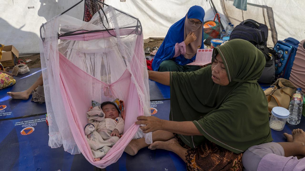 A woman and a baby in a tent
