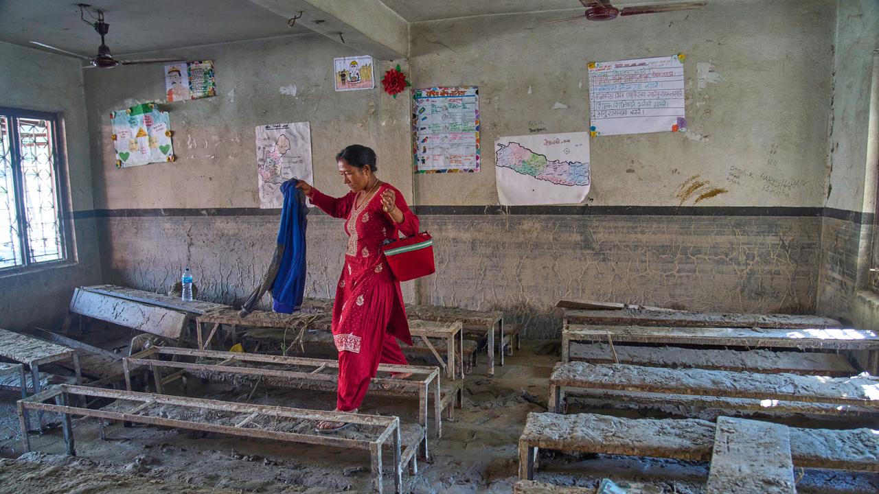A mother in a muddy classroom