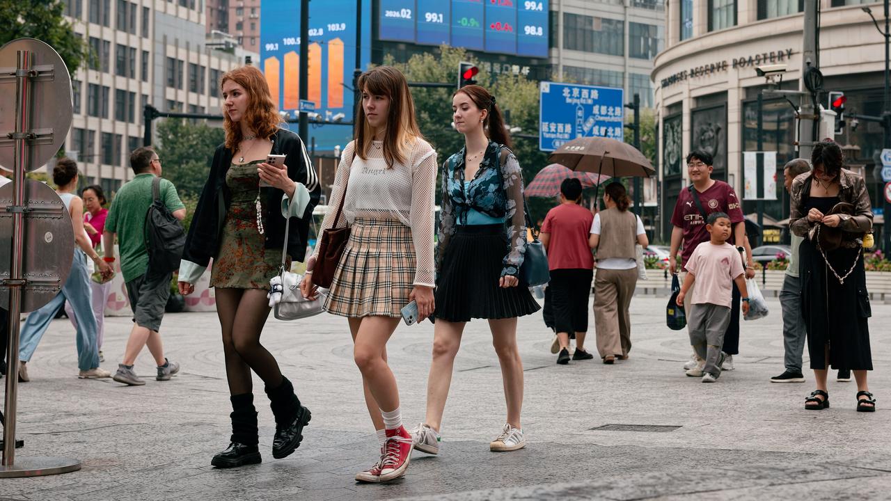 People walk on a street in Shanghai, China