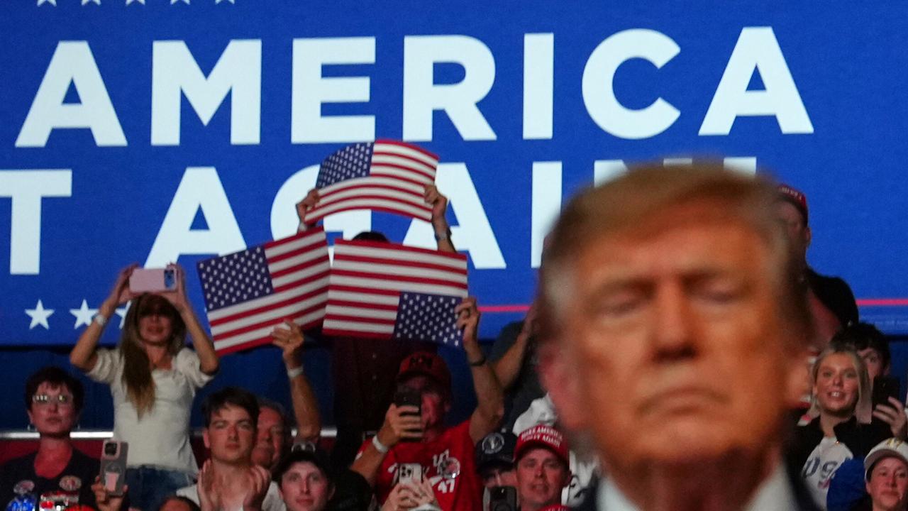 People cheer as President Donald Trump speaks at a campaign rally