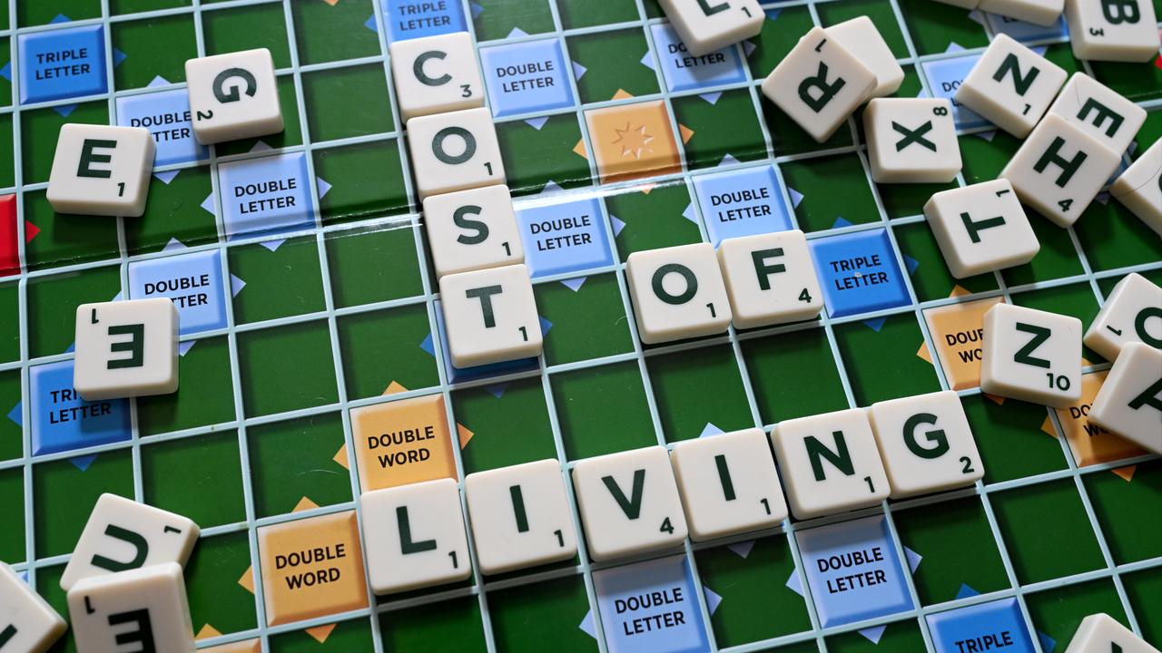 words 'Cost of Living' are seen on a scrabble board