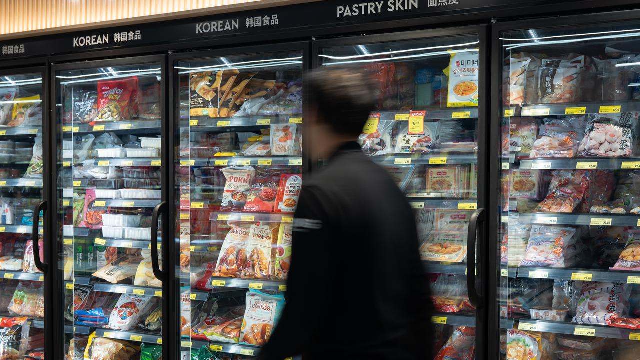 Customer browsing the supermarket freezer
