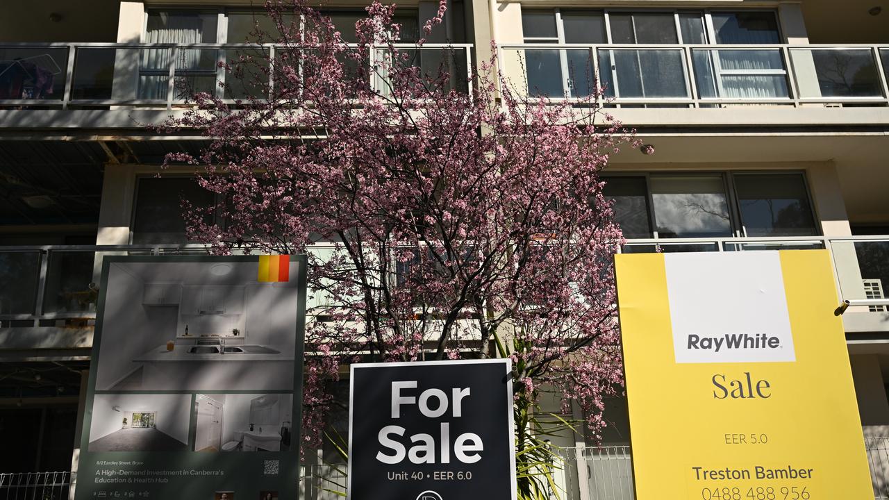 Sale signs are seen outside an apartment block in Canberra