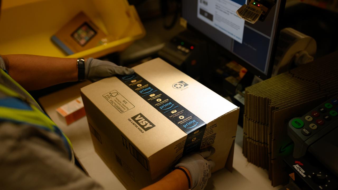 A worker packs a parcel at the Amazon Fulfilment Centre